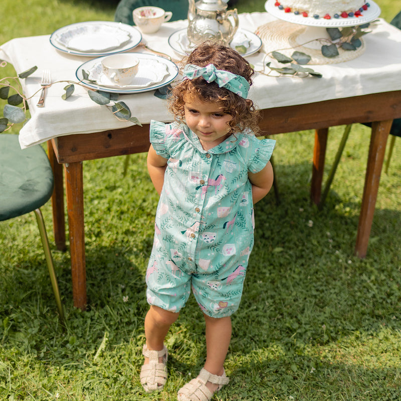 Turquoise romper in shimmering poplin with horse all over print by Souris Mini