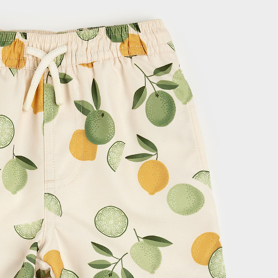 Citrus Print on Antique White Swim Trunks by Petit Lem